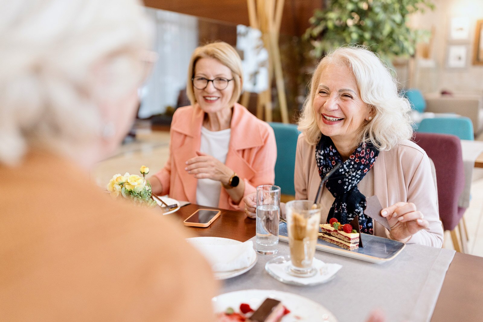 Senior women enjoying dessert and coffee together