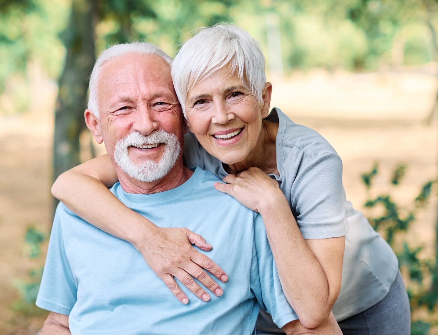 Smiling senior couple embracing outdoors in park